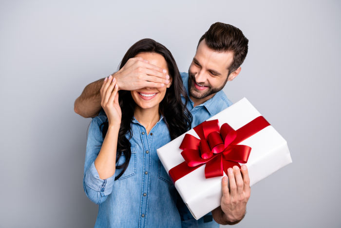 guy hide eyes and give gift to girlfriend