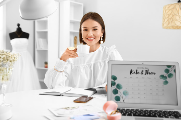 Female wedding planner drinking coffee in office