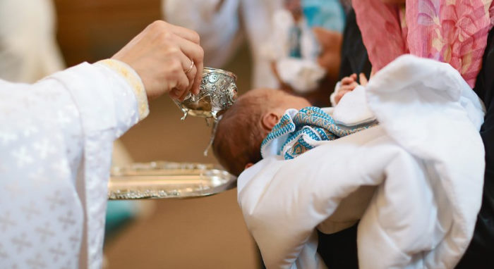 baby being baptized in church