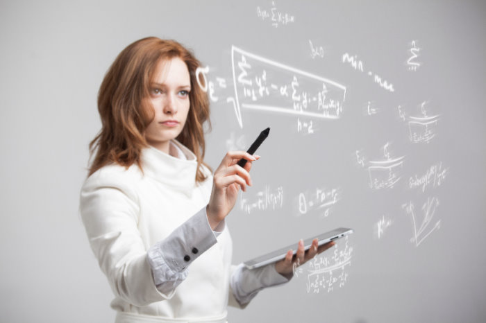 woman doing calculations on board