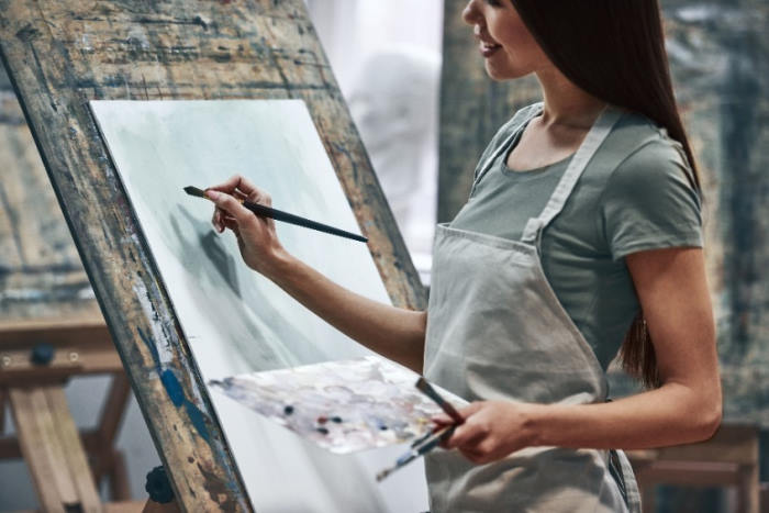 woman painting on canvas