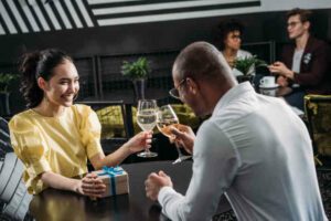 man and woman out for 6-month anniversary celebration with a gift